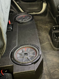 Close-up view of the BRP JT Jeep Gladiator underseat enclosure with two Kicker CompRT 10-inch subwoofers installed, providing deep bass under the rear seat