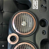 Close-up of a black JK/JKU American SoundBar showing one speaker, a tweeter, and part of a second speaker, all covered with a custom-colored mesh grill.