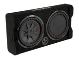 Down-firing subwoofer enclosure with Kicker CompRT subwoofers, featuring thin-profile design, shown with 10-inch or 12-inch subwoofer options on a plain white background