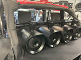 Four black JBL MT8HLB 8-inch marine tower speakers installed on a boat, shown with RGB LED lights turned off, highlighting their sleek and durable design