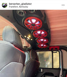 Black soundbar with red charcoal grilles covering the speakers and white lighting controlled by the Kicker RGB LED Controller, part of a custom Jeep audio system.