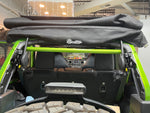 Green American Roll Bar installed in a JKU Jeep Wrangler (2007-2018), securely mounted to the stock roll bar and seat belt bracket.