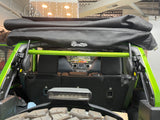 Green American Roll Bar installed in a JKU Jeep Wrangler (2007-2018), securely mounted to the stock roll bar and seat belt bracket.