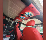 Red JK/JKU Kicker Kit American SoundBar installed in a car with matching red interior, featuring Kicker speakers with white charcoal grills and illuminated with aqua RGB lighting