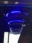 Black soundbar with mesh grilles and blue LED ring lights from the RGB LED Ring Light Kit installed in a Jeep, part of a custom audio system.