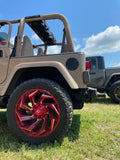 Black TJ American Soundbar enclosure installed in a Jeep with red rims, highlighting a custom Jeep TJ audio and visual setup.