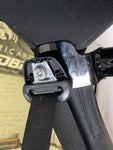 Close-up of the roll bar mounted flush on the stock back roll bar and securely connected to the seat belt bracket in a JKU Jeep Wrangler.