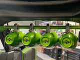 Green American Roll Bar installed in a JLU Jeep Wrangler (2007-2018), securely mounted to the stock roll bar and seat belt bracket with speakers