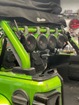 Green roll bar installed in a green Jeep, featuring 4 attached speakers, part of the JLU Jeep American RollBar for 2018-Present models - Side View