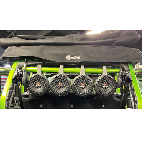 Green roll bar installed in a green Jeep, featuring 4 attached speakers, part of the JLU Jeep American RollBar for 2018-Present models.