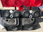 Red TJ American Soundbar enclosure with no speakers next to a black soundbar with speakers and a subwoofer beneath it, showcasing a custom Jeep TJ audio system.